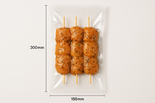 Clear smooth vacuum bag, 150mm x 300mm, with chicken kebabs. Professional photo with light.